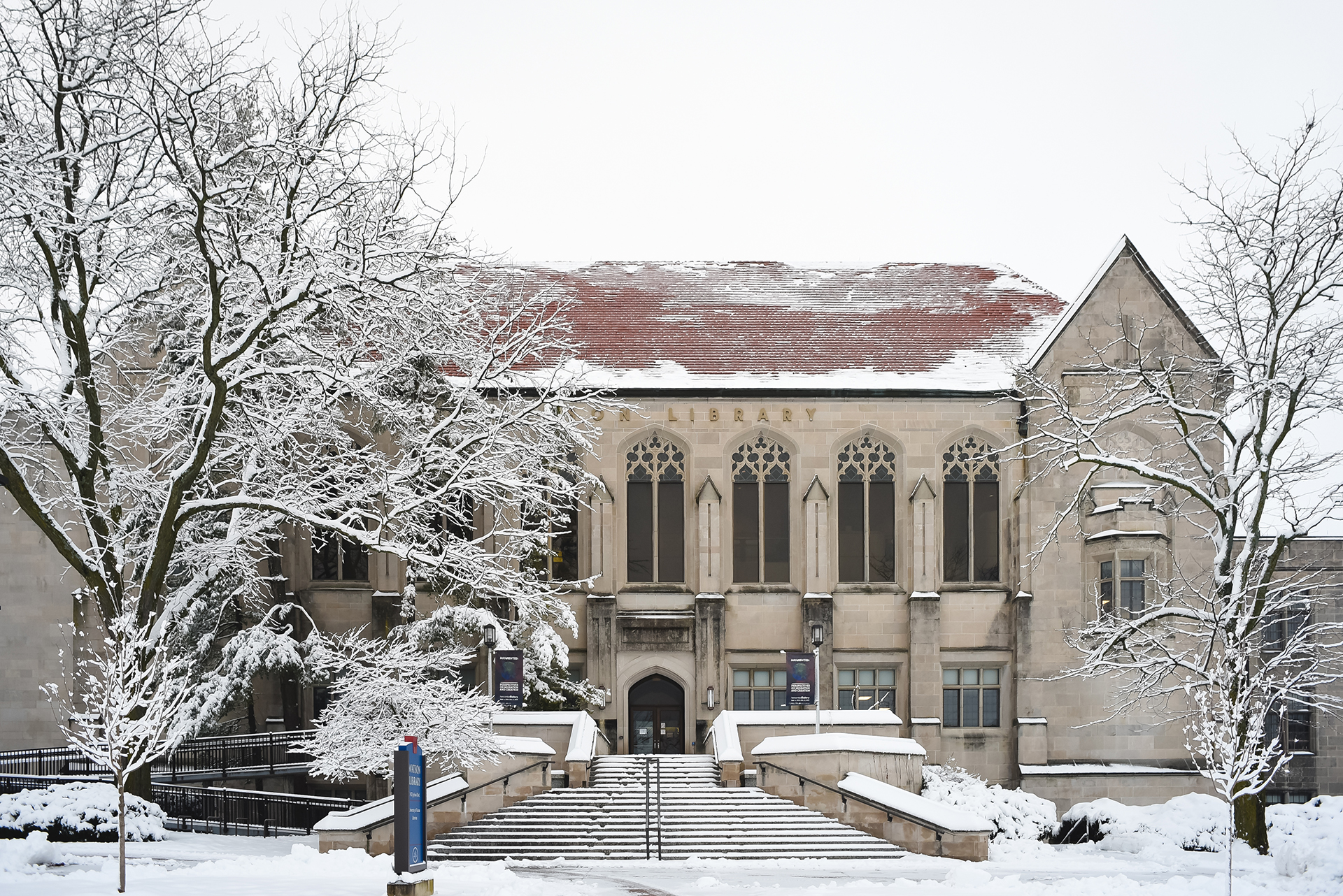 Watson Library in winter, snow on ground and trees