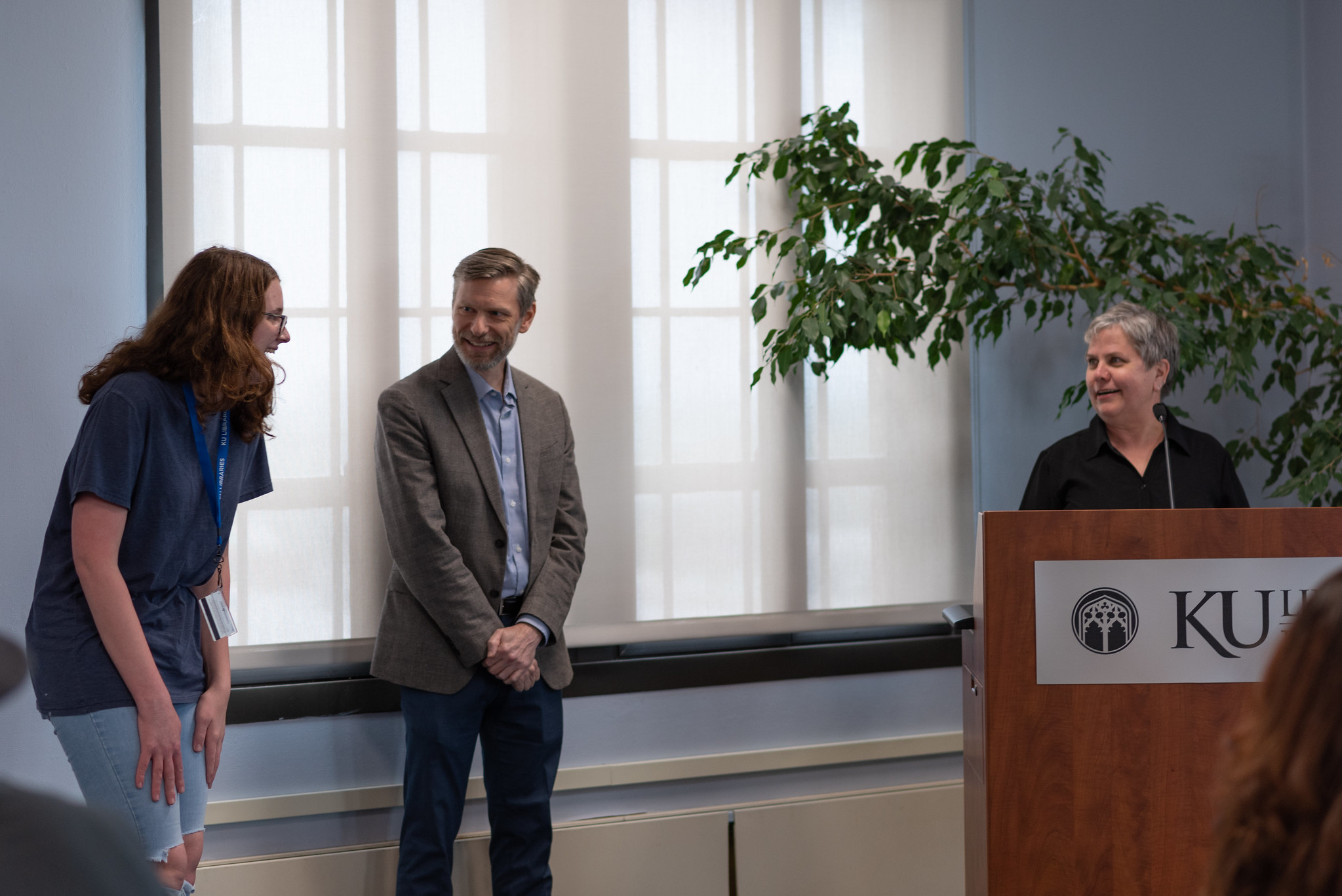 Jenna Bellemere receives a DASEE from KU Libraries interim co-deans Beth Whittaker and Scott Hanrath.